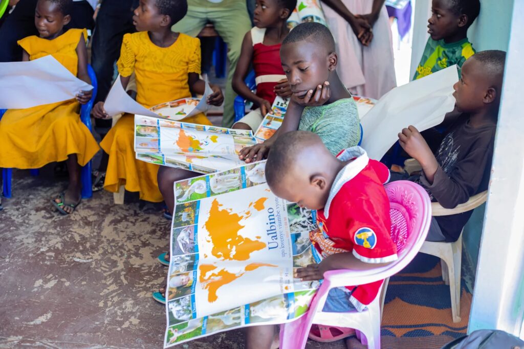 Children reading maps in a classroom.